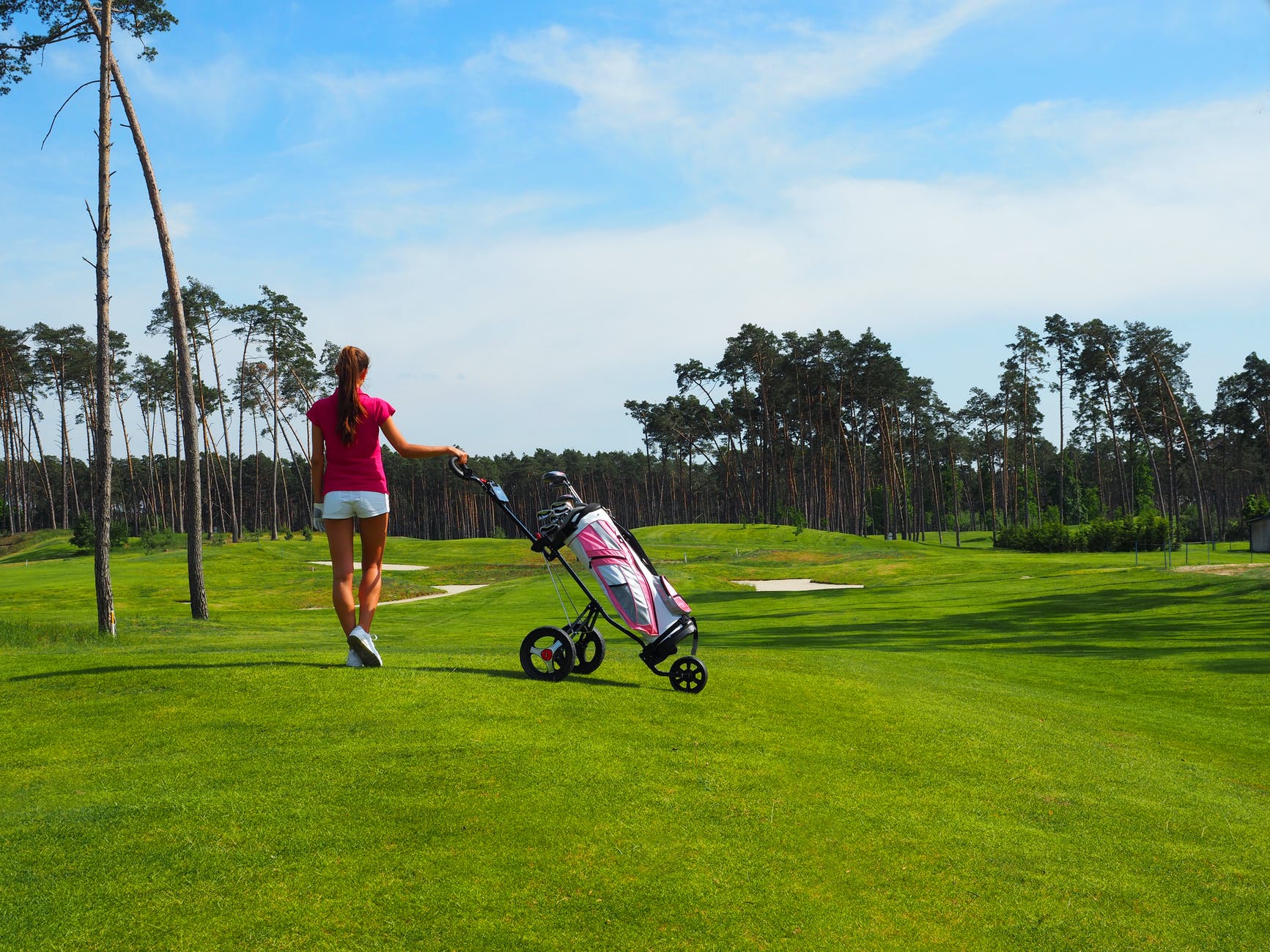 back view of a woman walking at a golf course