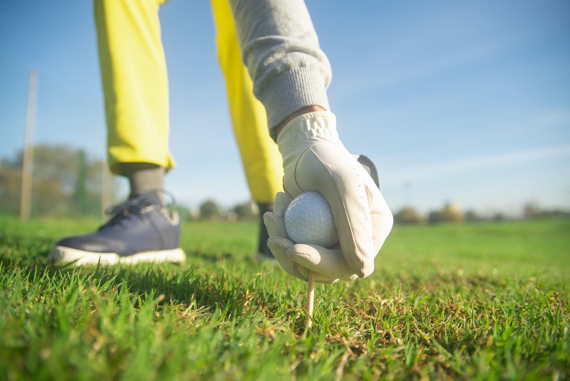 a person wearing a glove while holding a golf ball