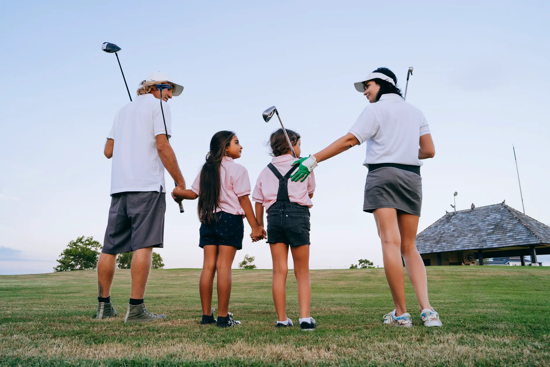 family playing golf