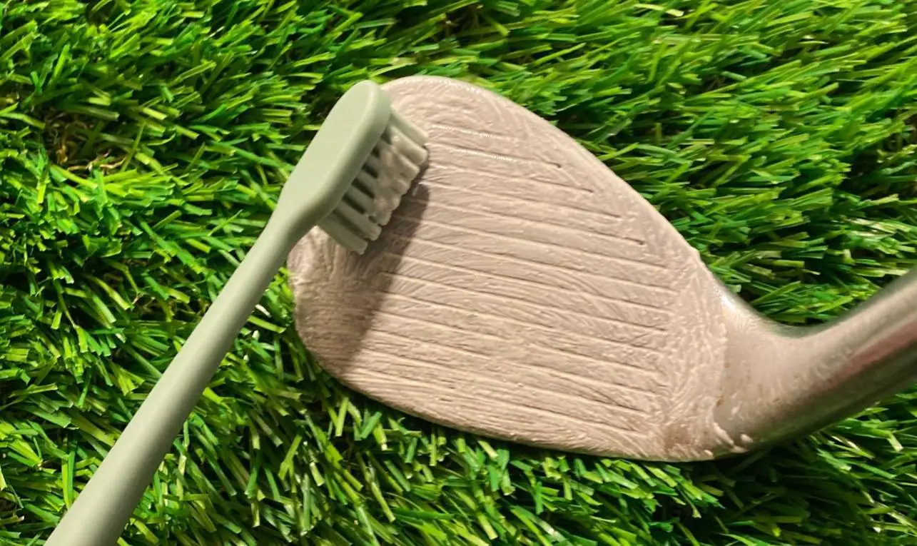 clean golf club with toothpaste