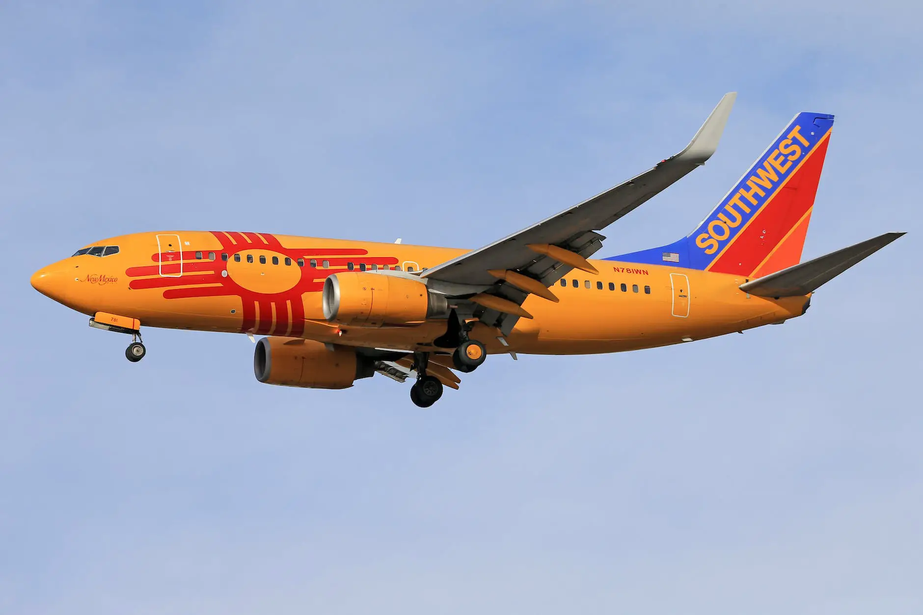 an orange passenger plane in the sky