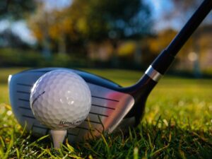 a golf ball and golf club in close up photography